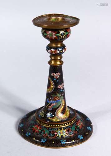 A GOOD 19TH CENTURY CHINESE CLOISONNE CANDLESTICK, decorated upon a black ground with scenes of a