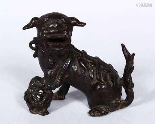 A GOOD EARLY CHINESE POSS MING BRONZE FIGURE OF KYLIN, in a seated position wwith his paw upon a