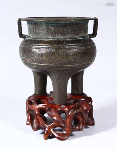 A CHINESE MING DYNASTY BRONZE TRIPOD CENSER, with a band of archaic style decoration and twin