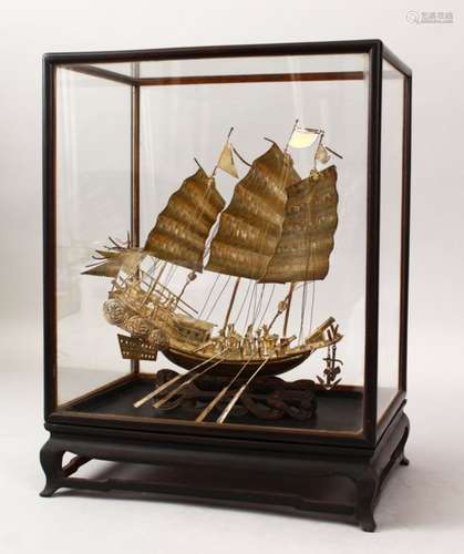 A 19TH CENTURY CHINESE SOLID SILVER CASED MODEL OF A JUNK / SHIP, the junk housed within a