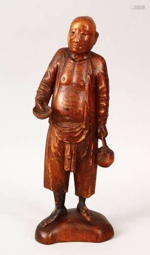 A 19TH / 20TH CENTURY CHINESE BOXWOOD CARVED FIGURE OF A MAN, the man holding a teapot in one hand