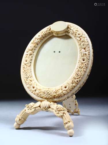 AN 19TH CENTURY SOUTH INDIAN OR SRI LANKAN IVORY PHOTOGRAPH FRAME, the oval frame carved with lions,