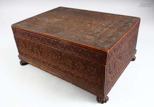 A 19TH CENTURY INDIAN CARVED SANDALWOOD BOX, the cover opening to reveal a removable tray with