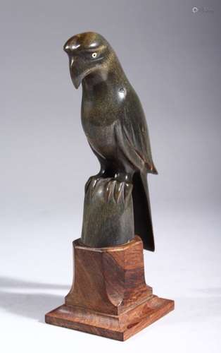 A CARVED MODEL OF A PARROT, possibly rhino horn, on a hardwood stand, 18cm high overall.