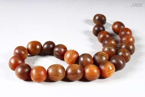 A BEAD NECKLACE, possibly rhino horn, comprising 25 beads, approx 15mm and smaller, weight 55g.