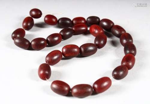 A BEAD NECKLACE, possibly rhino horn, comprising 27 oval beads, approx. 15mm wide and smaller,