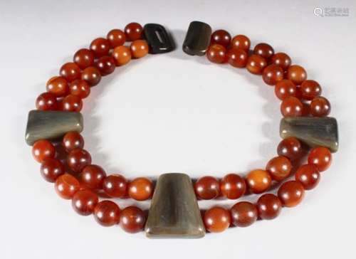 A DOUBLE-ROW BEAD NECKLACE, possibly rhino horn, comprising 48 beads, approx. 15mm and smaller,