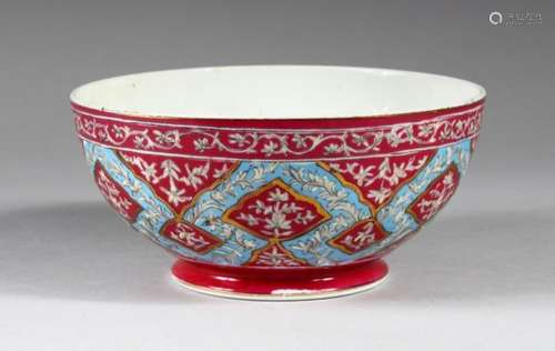 A 20TH CENTURY QAJAR PORCELAIN BOWL, with pink, blue and gilded decoration, 16cm diameter.