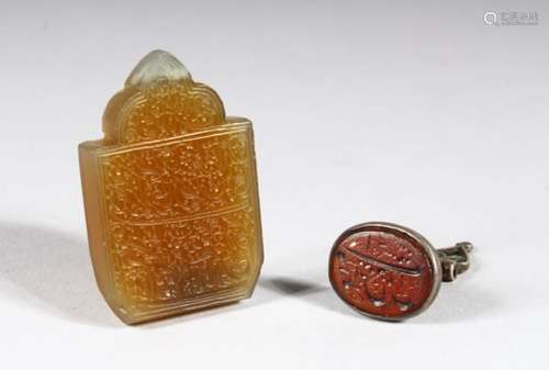 AN ISLAMIC SILVER AND HARDSTONE FOB SEAL, and an engraved hardstone pendant.