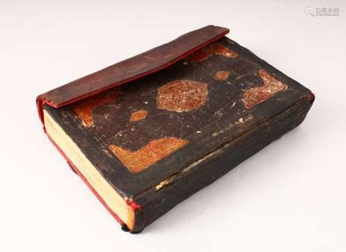 AN EARLY LEATHER BOUND OTTOMAN QURAN, 17cm x 12.5cm.