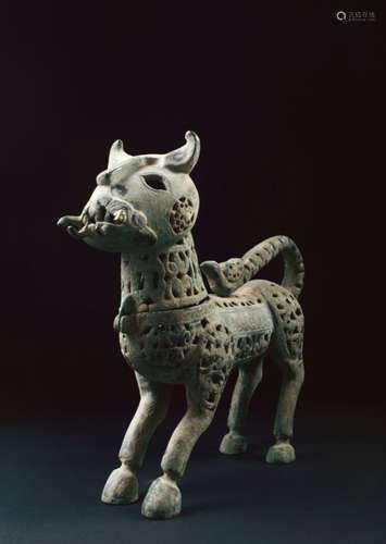 A CAST BRONZE INCENSE BURNER, modelled as a stylised lion with engraved calligraphy decoration, 35cm