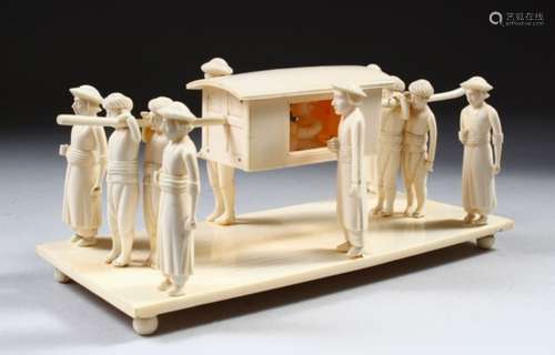 A CARVED IVORY GROUP DEPICTING FIGURES CARRYING A DIGNITARY, 20cm long.