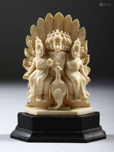 A SMALL INDIAN CARVED IVORY GODDESS GROUP, on a wooden base, 11cm high.