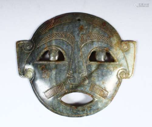 A CARVED JADE MASK, 14.5cm wide.