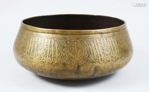 A 14TH / 15TH CENTURY MAMLUK BRASS BASIN, The body with calligraphic decoration, 27cm diameter x