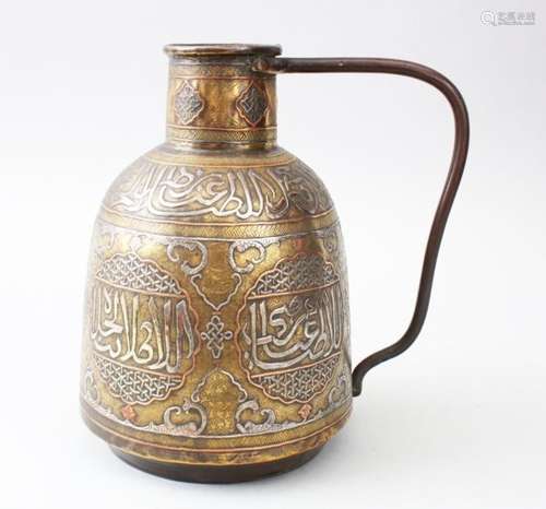 A LATE 19TH CENTURY ISLAMIC DAMASCUS BRASS PITCHER, inlaid in silver and copper, with calligraphy,