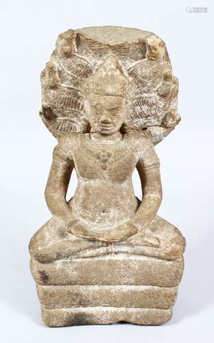 A 18TH/19TH CENTURY CARVED STONE GANDHARA, in a seated position, (af), 32cm high.