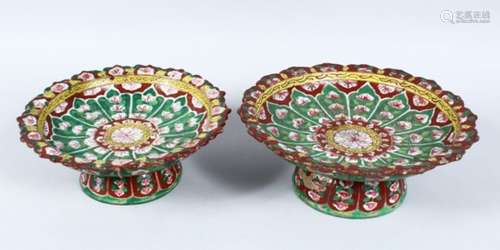 TWO SIMILAR INDIAN POTTERY TAZZAS, hand painted with a floral design, 20.5cm and 25cm diameter.