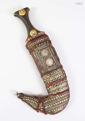 A GOOD 19TH CENTURY OR EARLIER ISLAMIC JAMBIYA DAGGER, with a leather sheath decorated with silver