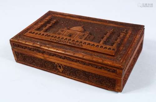 A GOOD INDIAN CARVED HARDWOOD LIDDED BOX, carved in relief to depict the scenes of a temple