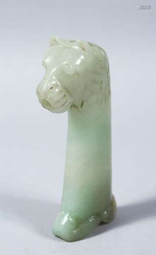 A 19TH CENTURY INDIAN MUGAL CARVED JADE DAGGER HANDLE OF A LION / BEAST, 12cm high x 7cm wide.