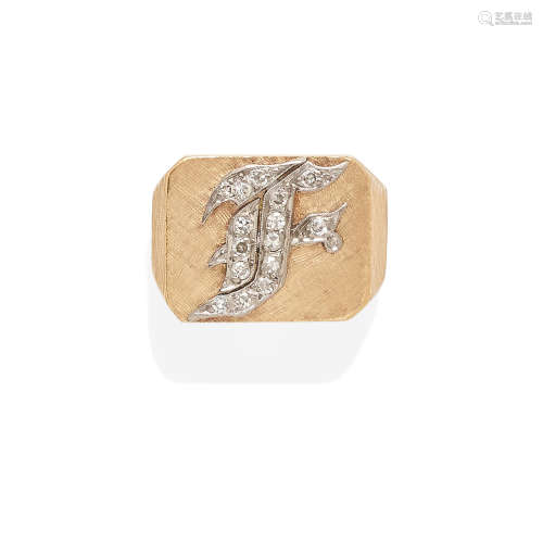 a gold and diamond monogram ring