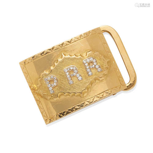 a gold and diamond monogram belt buckle