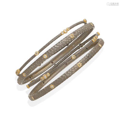 A collection of four diamond bangles