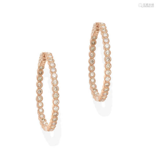 a pair of rose gold and diamond hoop earrings