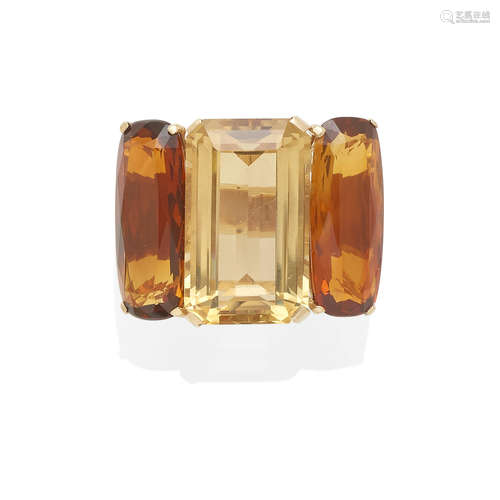 A gold and topaz three stone ring