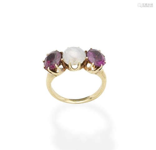 A star sapphire and garnet three-stone ring