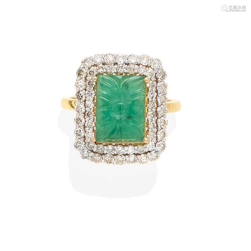 A carved emerald and diamond ring