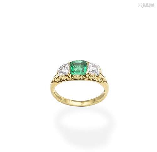 An emerald and diamond three-stone ring