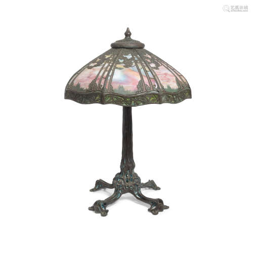 A Slag Glass and Patinated Metal Table Lamp  First half 20th centuryheight of base 29 1/2in (74.9cm); diameter of shade 26in (66cm)