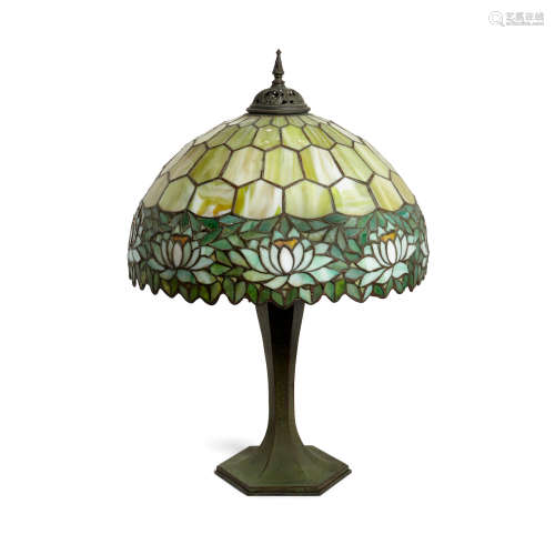 A Unique Art and Glass Company Leaded Glass and Patinated Metal Table Lamp   Circa 1910height 27in (68.5cm); diameter of shade 18in (45.7cm)