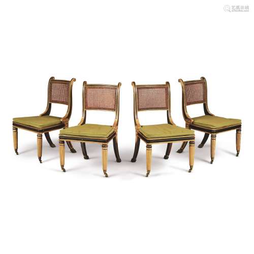A SET OF FOUR REGENCY GILT AND EBONISED WOOD CANED SIDE CHAIRS IN THE MANNER OF HENRY HOLLAND, EARLY 19TH CENTURY