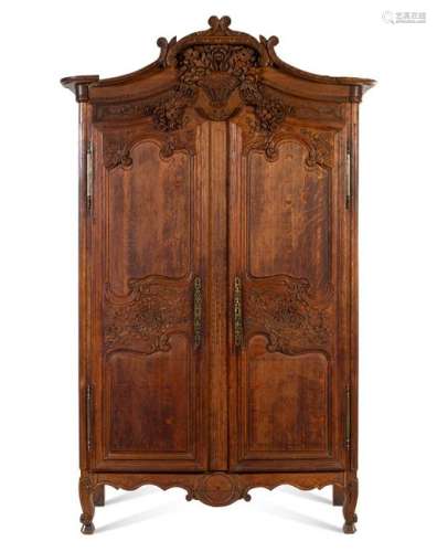 A French Provincial Carved Oak Armoire