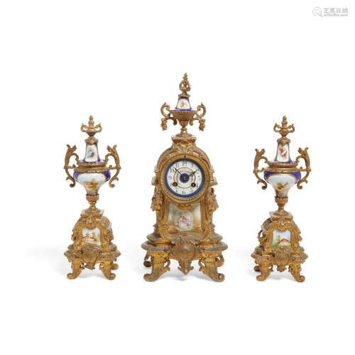 A Napoleon III Style Gilt Metal and Porcelain Three Piece Clock Garniture