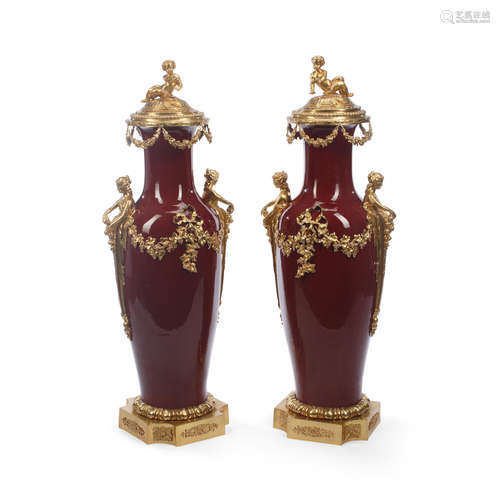 A Pair of Louis XV Style Gilt Bronze Mounted Sang de Boeuf porcelain  Covered Vases