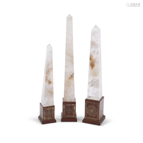 A Group of Three Rock Crystal Obelisks on Inlaid Stands