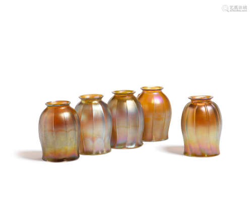 Five Tiffany Studios Favrile Glass Shades   Circa 1900Four shades engraved L.C.T. Favrile, one shade engraved 5-L.C.T. Favrile.heights 5 and 5 1/4in (12.7 and 13.3cm); diameter 3 1/4in (8.2cm)