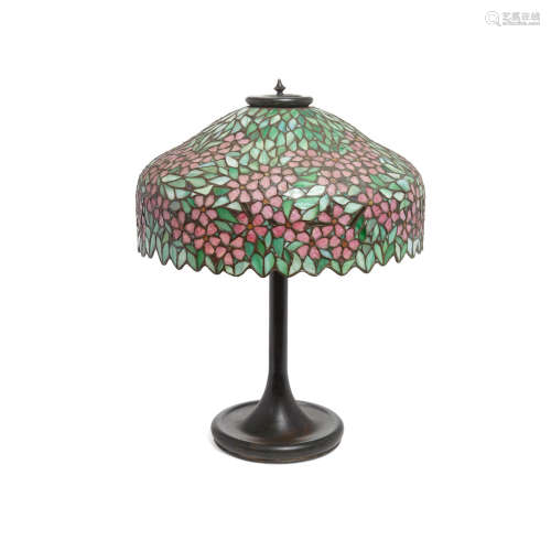 A Unique Art Glass and Metal Company Leaded Glass and Patinated Copper Lamp  circa 1910The underside of the base inscribed OL #2278598.height 24 1/4in (61.5cm); diameter of shade 18 1/4in (46.3cm)