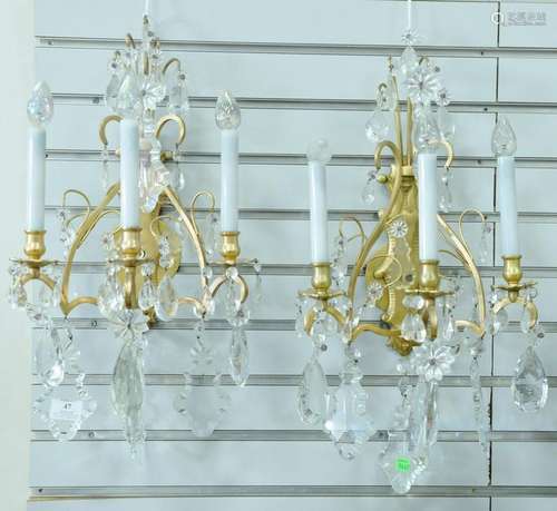 Pair of bronze and crystal sconces, each having three