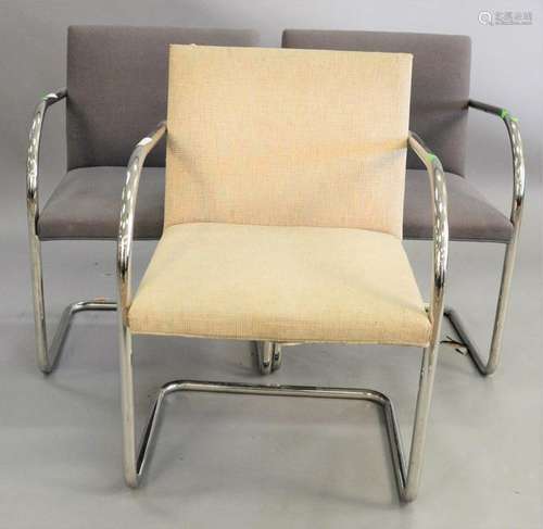 Three Knoll chrome armchairs.