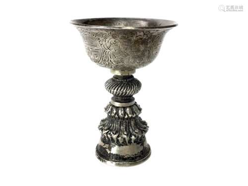 A CHINESE/TIBETAN WHITE METAL LIBATION CUP