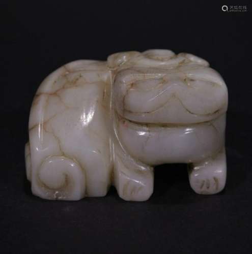 A CARVED HETIAN JADE ORNAMENT OF LION
