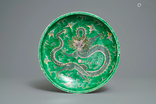 A Chinese verte biscuit 'dragon' charger, Kangxi mark,