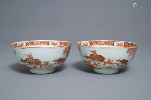 A pair of Chinese iron red bowls with a kiting boy on