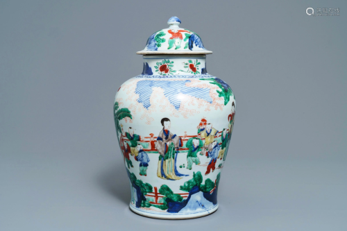 A Chinese wucai vase and cover with figures in a