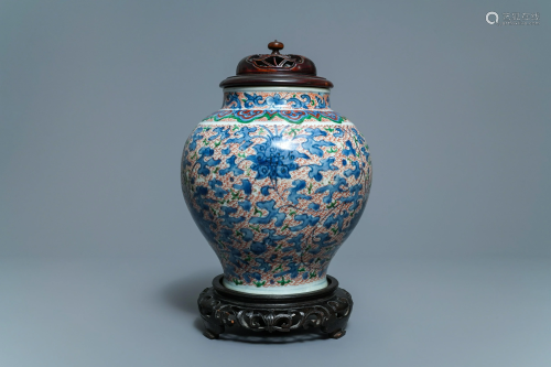 A Chinese wucai 'lotus scroll' jar with wooden cover